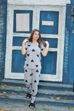 a woman holding a cell phone in front of a building 