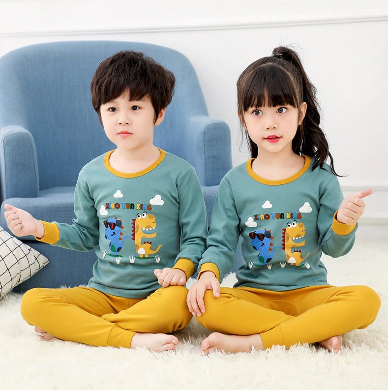 a couple of kids sitting on top of snow covered ground 