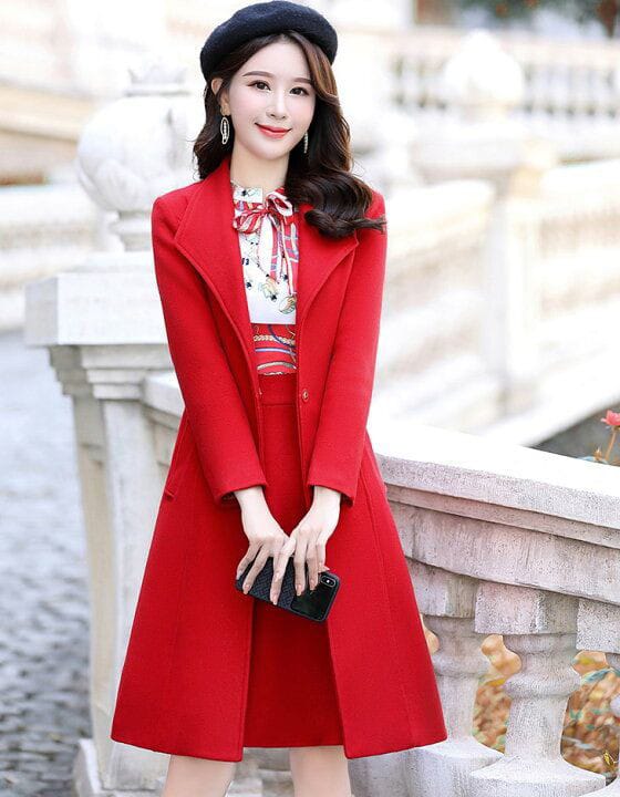 a woman in a red dress holding a cell phone 