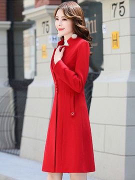 a woman in a red dress is talking on a cell phone 