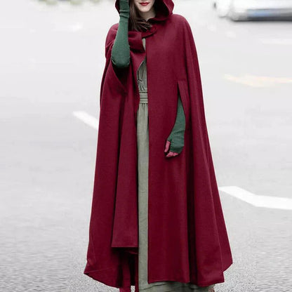 a woman in a red dress standing in the snow 