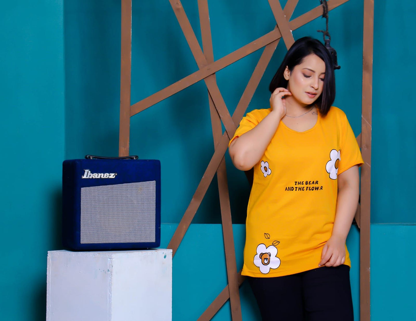 a woman standing in front of a laptop computer 