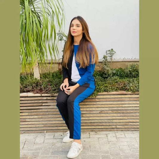 a woman is sitting on a wooden bench 