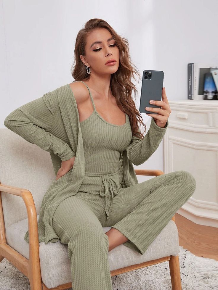 a woman sitting on a chair with a cell phone 