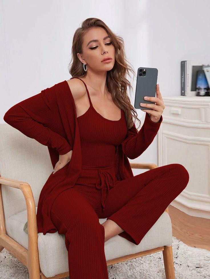 a woman sitting on a chair holding a cell phone 