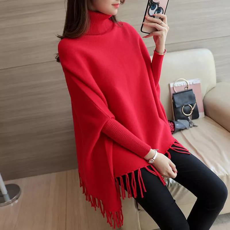 a woman in a red sweater holding a cell phone 