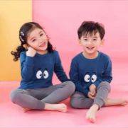 a group of children sitting on a pink floor 