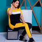 a woman sitting on a chair holding a laptop 