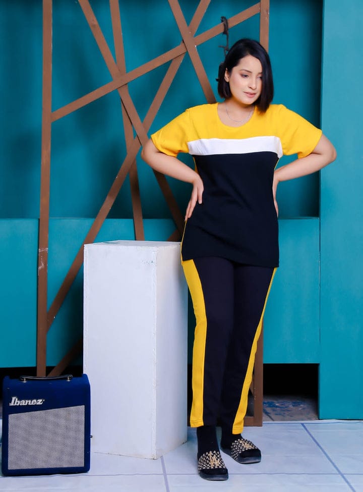 a woman standing in front of a wall holding a surfboard 