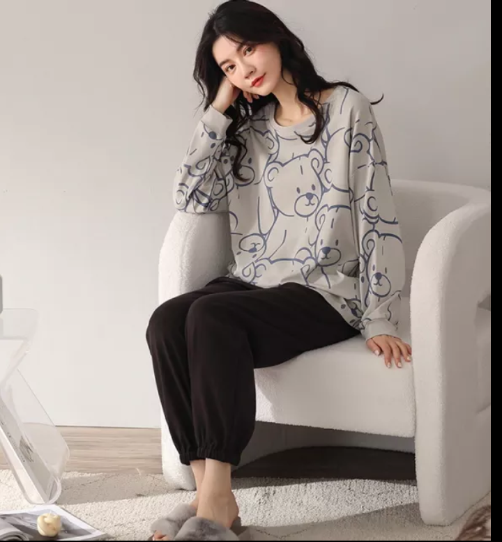 a woman sitting on a white toilet talking on a cell phone 