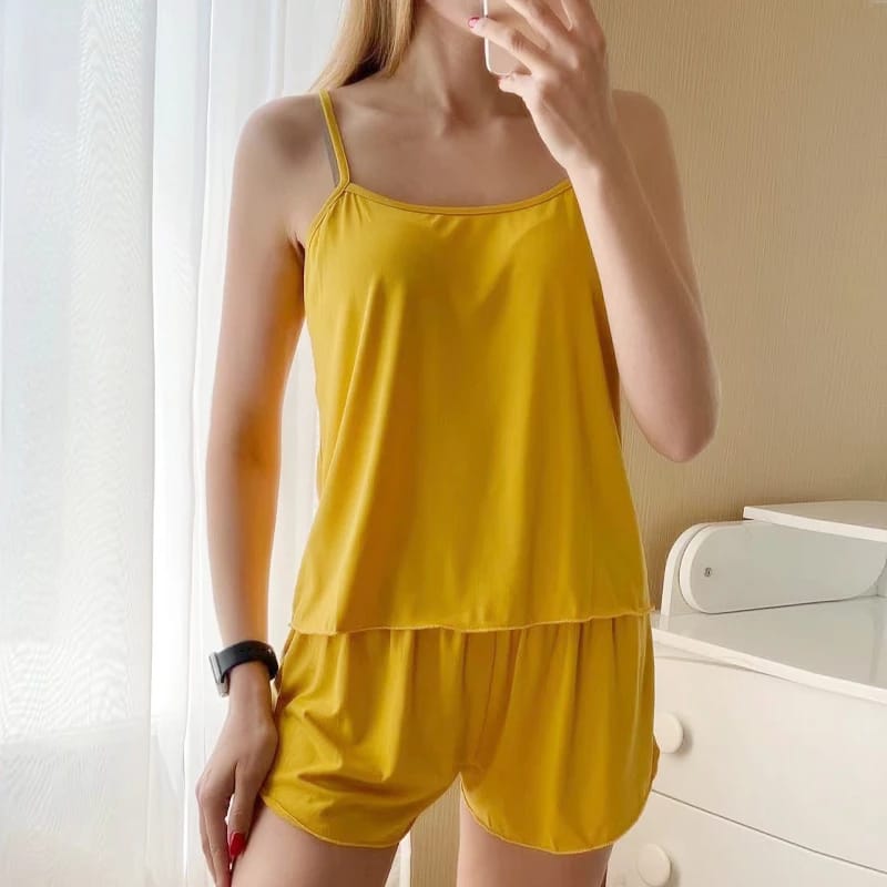 a woman in a yellow dress holding a cell phone 