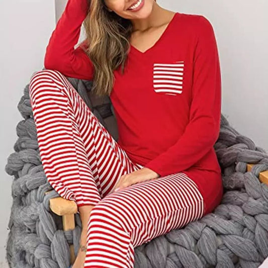 a woman sitting on a bed holding a cell phone 