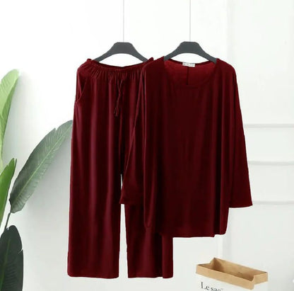 a red robe is hanging on a wall 