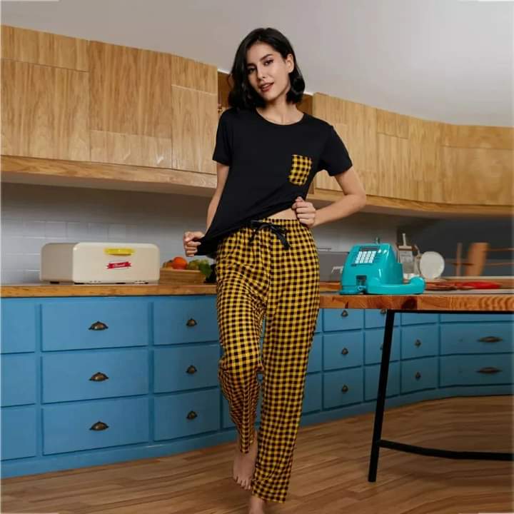 a woman standing in a kitchen next to a counter 